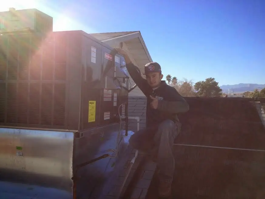 HVAC technician performing Boiler Repair on a rooftop unit in Daly City